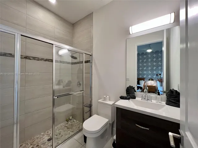 an aerial view of a house with swimming pool garden and patio