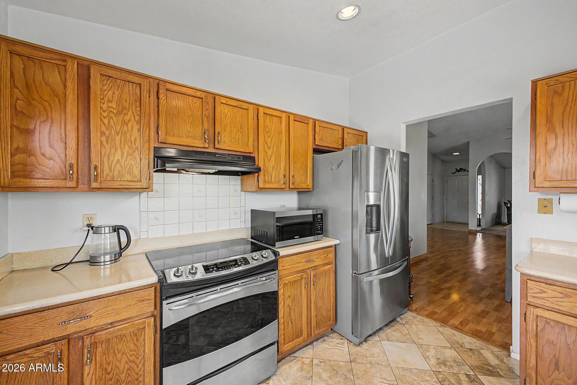 2659 West Hearn Road Phoenix, AZ 85023 - Photo 10 of 25 a kitchen with stainless steel appliances granite countertop a stove a refrigerator and a sink