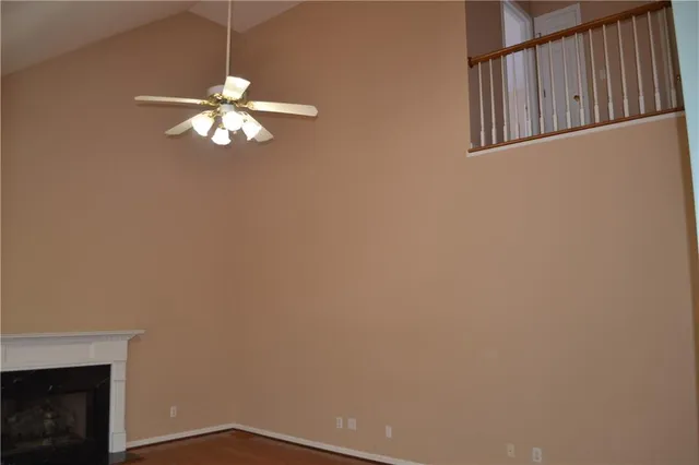 a view of an empty room with a fireplace