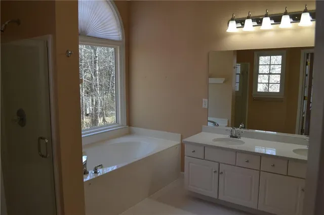 a white toilet sitting next to a shower