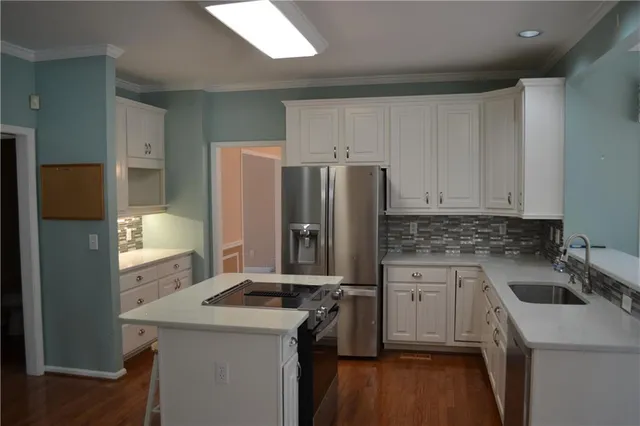a kitchen with a sink a stove and refrigerator