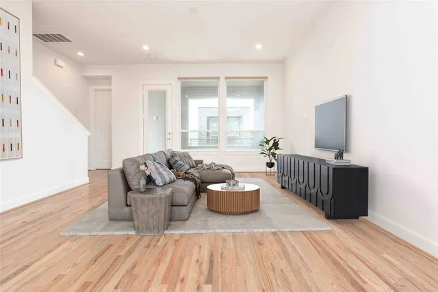 a living room with furniture and wooden floor