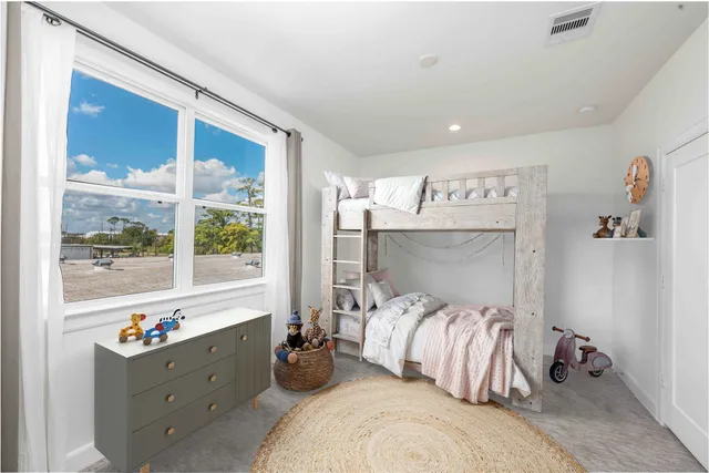 a bathroom with a bathtub shower sink vanity mirror and toilet