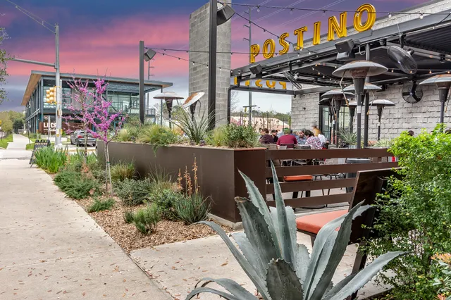 a view of a brick building with a yard in front of it