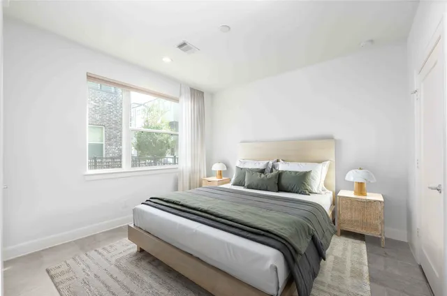 a bedroom with a bed and a window