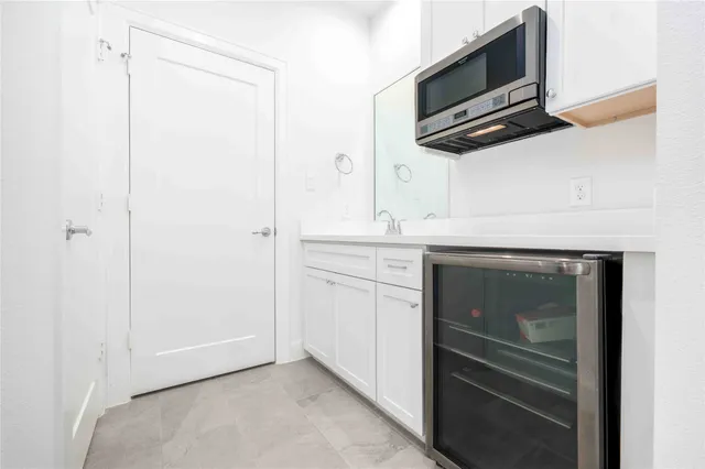 a kitchen with a refrigerator and microwave