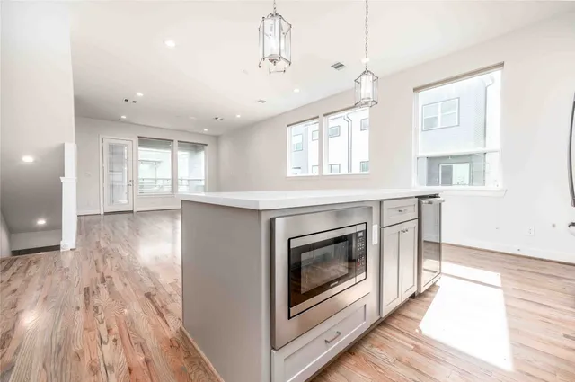 a view of kitchen and hall with wooden floor