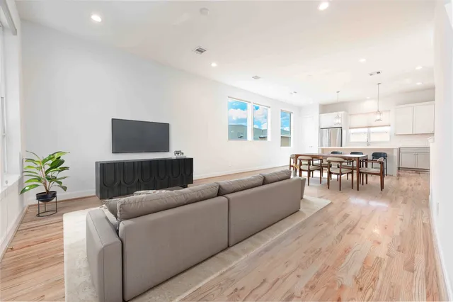 a living room with furniture and wooden floor