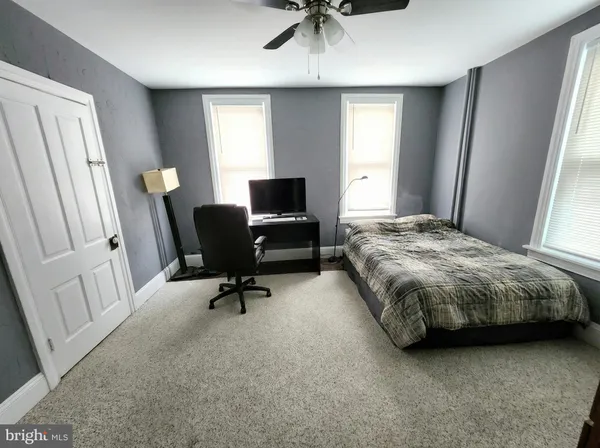 a bedroom with a bed and a chair