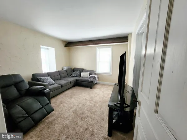 a living room with furniture and a mirror