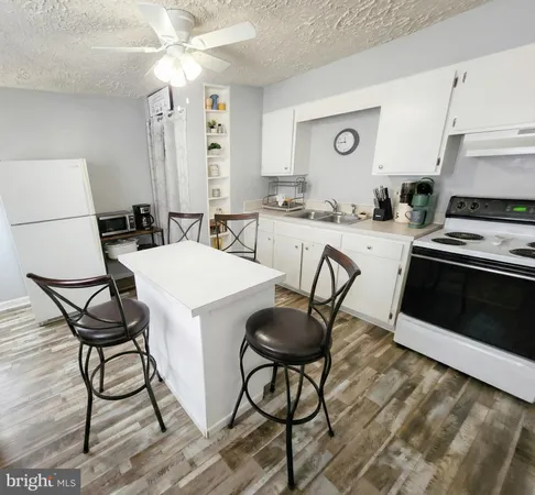 a kitchen with stainless steel appliances a stove a sink refrigerator and cabinets