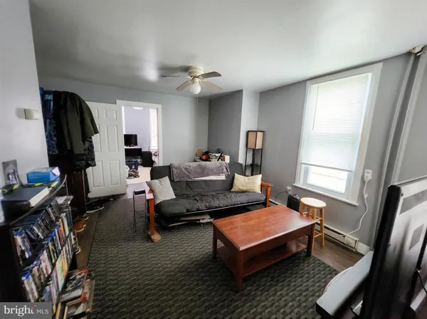 a living room with furniture a rug and a window