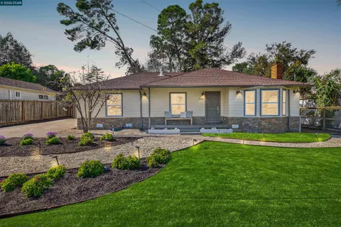 a front view of a house with swimming pool having outdoor seating