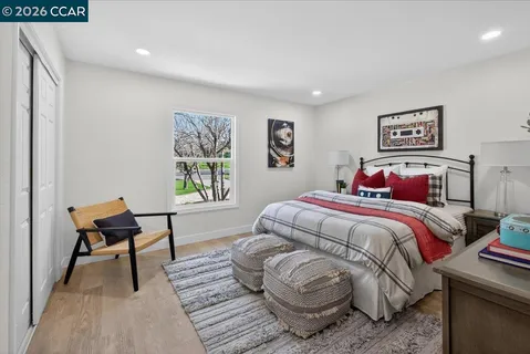 a bedroom with a bed and a chair