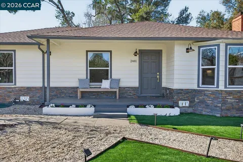 a front view of a house with garden