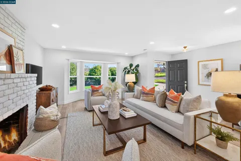a living room with furniture and a fireplace