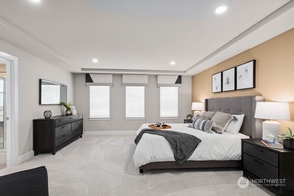 4011 171st Place Southeast Bothell, WA 98012 - Photo 18 of 33 a spacious bedroom with a large bed and a couch