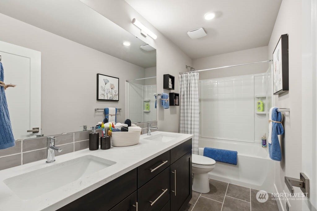 4011 171st Place Southeast Bothell, WA 98012 - Photo 27 of 33 a bathroom with a double vanity sink toilet and shower