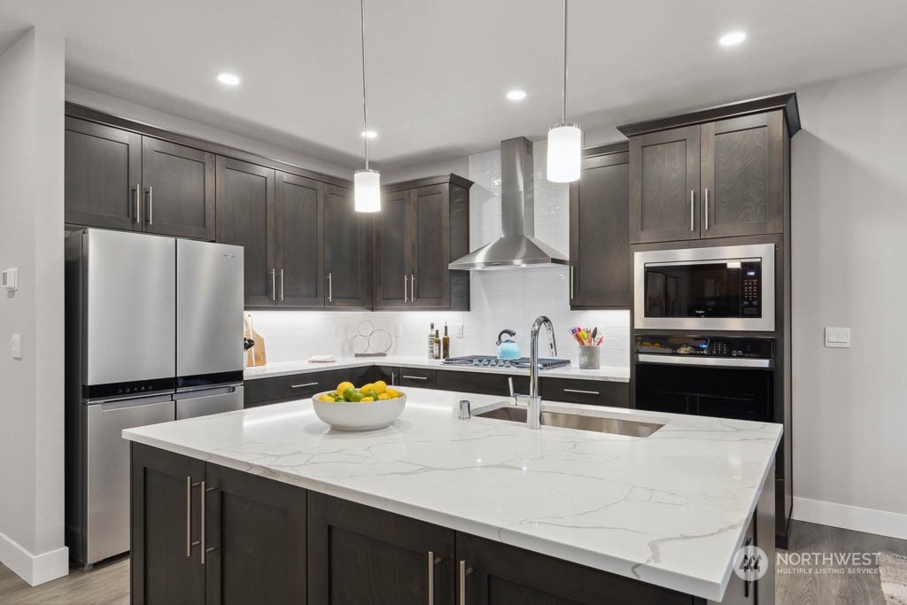 4011 171st Place Southeast Bothell, WA 98012 - Photo 4 of 33 a kitchen with stainless steel appliances a sink stove and refrigerator