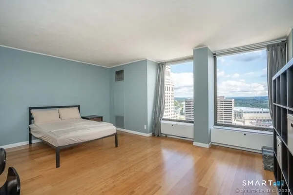 a bedroom with a bed and a window