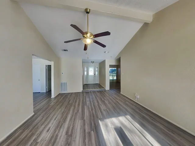 wooden floor in an empty room with a window