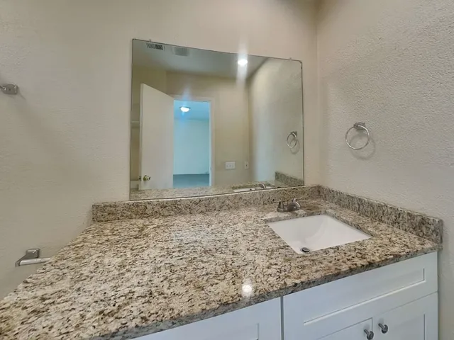 a view of an empty room and a ceiling fan