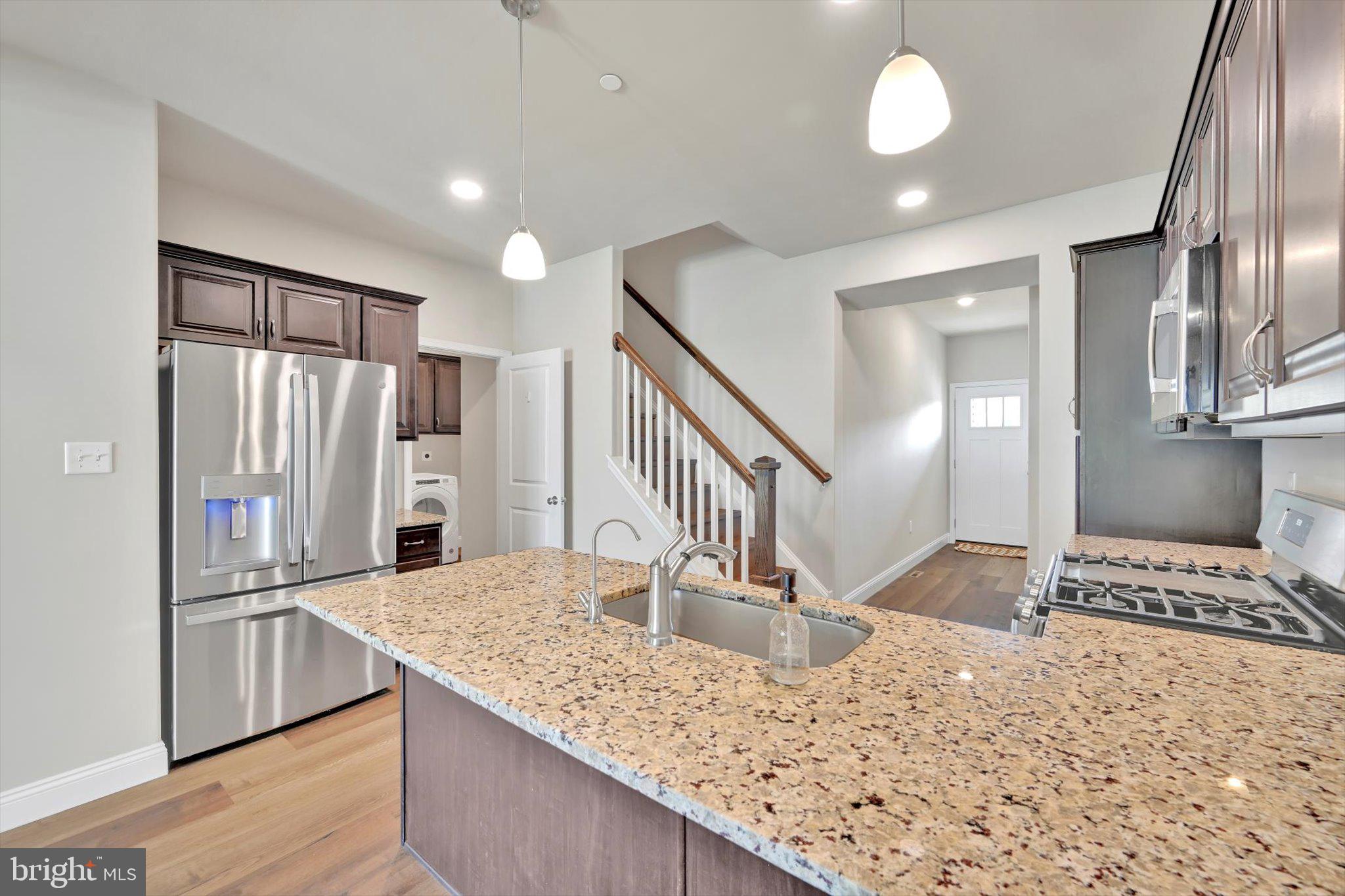 10 Hubbardton Court Sinking Spring, PA 19608 - Photo 5 of 25 a kitchen with stainless steel appliances kitchen island granite countertop a refrigerator and a stove
