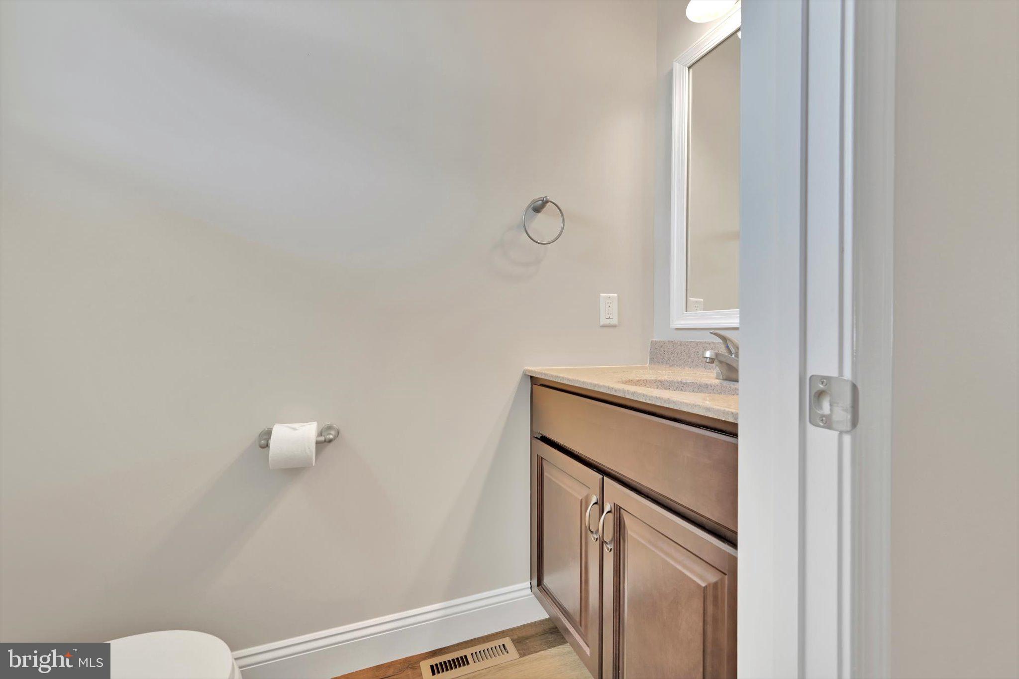10 Hubbardton Court Sinking Spring, PA 19608 - Photo 7 of 25 a bathroom with a sink a toilet and a mirror