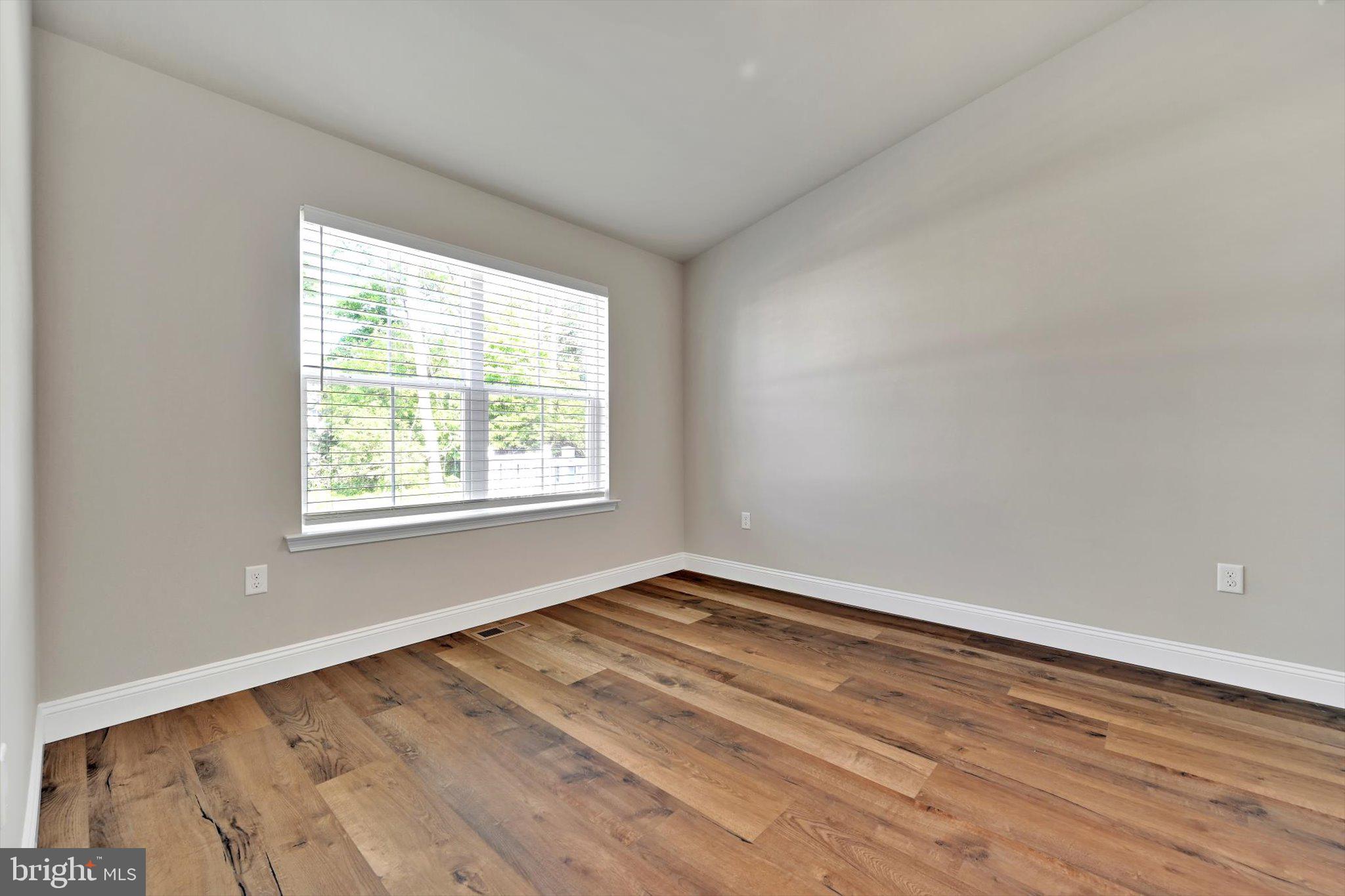 10 Hubbardton Court Sinking Spring, PA 19608 - Photo 9 of 25 wooden floor in an empty room with a window