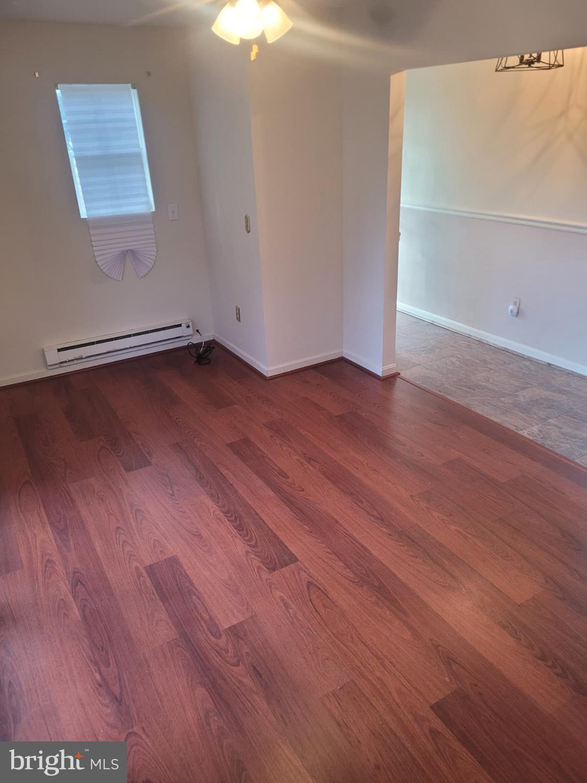 10926 Riverview Road Fort Washington, MD 20744 - Photo 12 of 15 an empty room with wooden floor and windows