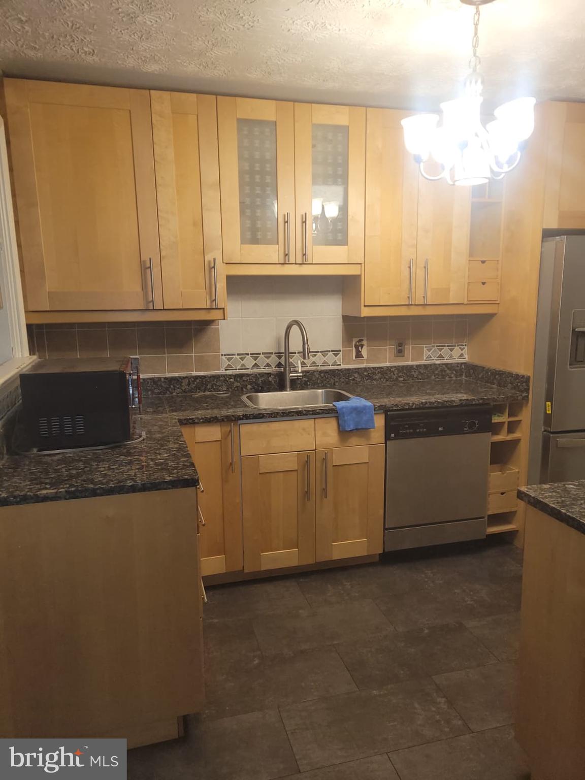 10926 Riverview Road Fort Washington, MD 20744 - Photo 6 of 15 a kitchen with stainless steel appliances granite countertop a sink a stove and a refrigerator