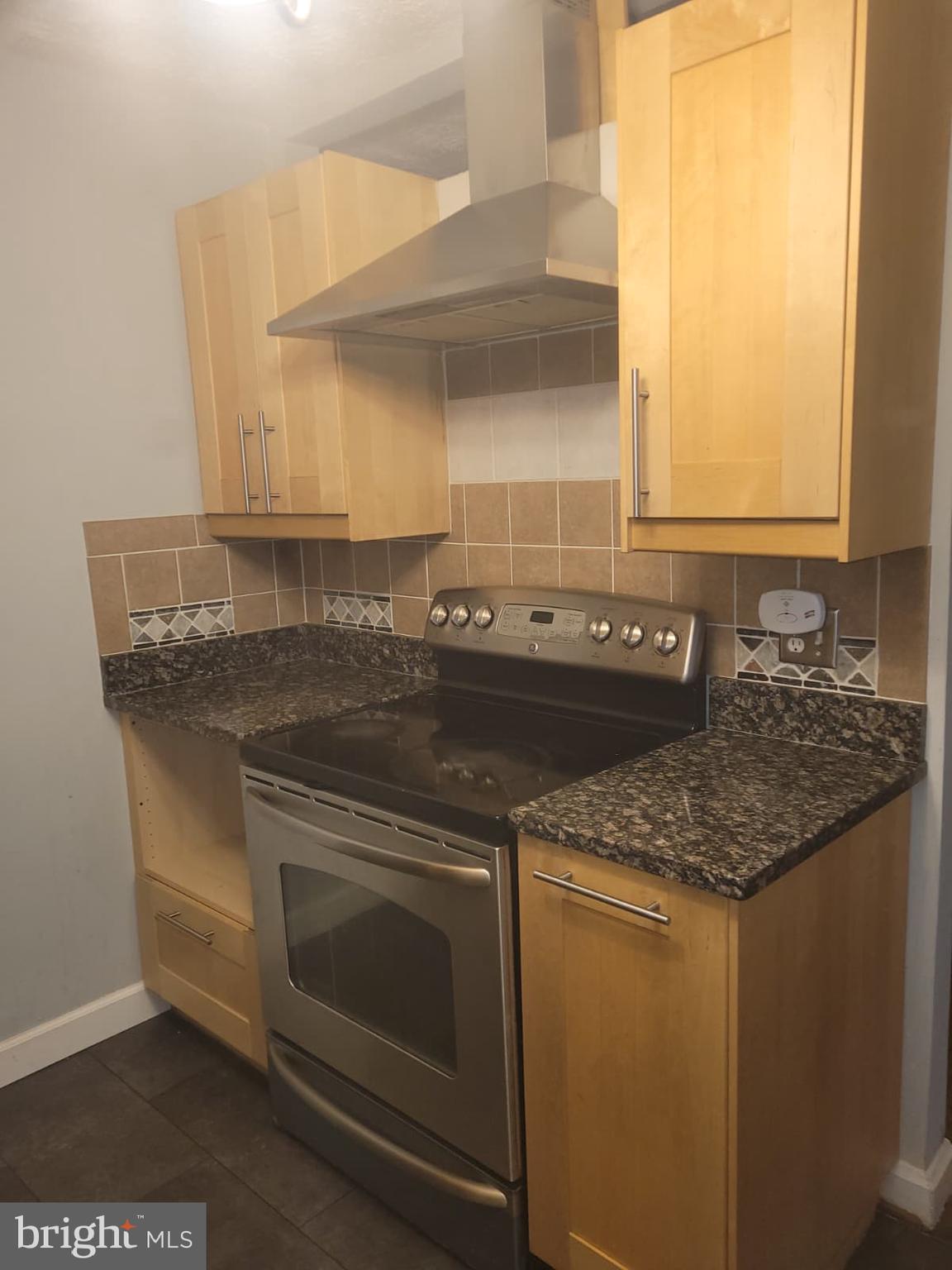 10926 Riverview Road Fort Washington, MD 20744 - Photo 7 of 15 a kitchen with granite countertop a sink and a stove