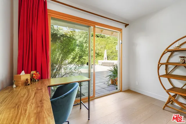 a view of a room with gym equipment and large windows