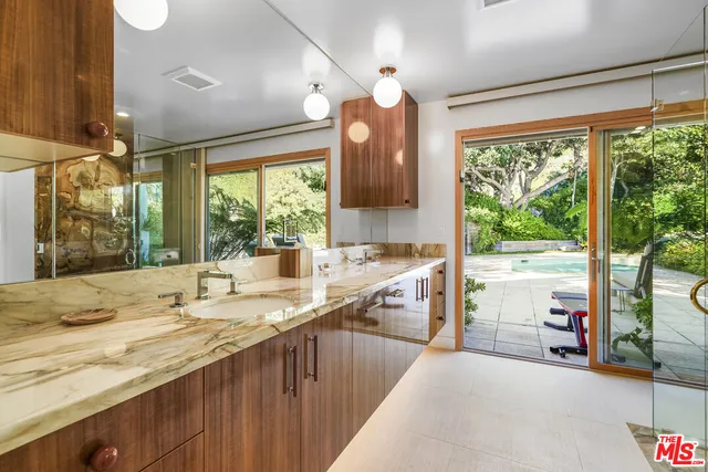 a kitchen with kitchen island a large window appliances and cabinets