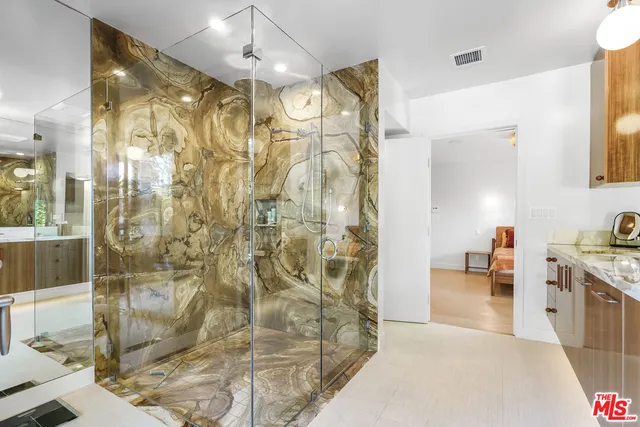 a spacious bathroom with a shower and a sink