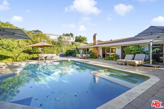 a view of a swimming pool with a patio