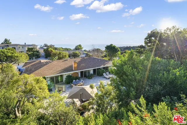an aerial view of a house with yard swimming pool and outdoor seating