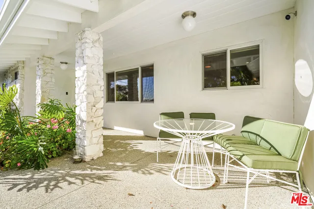 a view of a dining room with furniture and a potted plant
