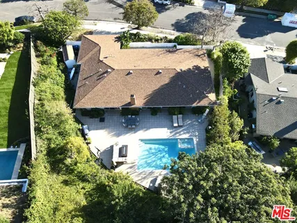 an aerial view of a house with yard swimming pool and outdoor seating