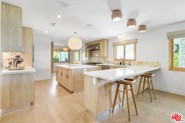 a large kitchen with a table and chairs