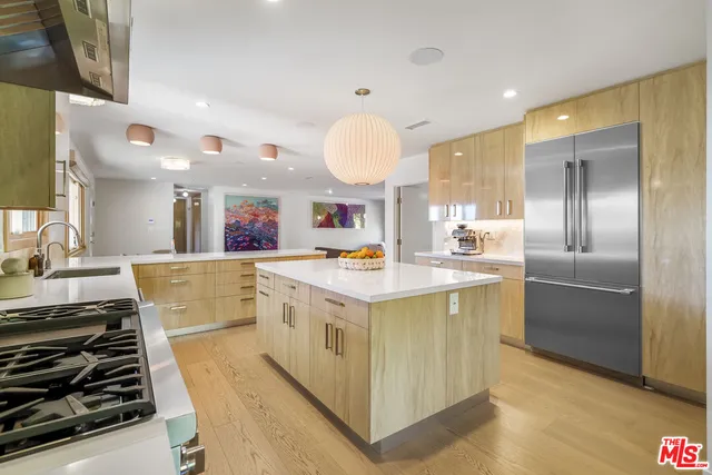 a large kitchen with a stove and a refrigerator