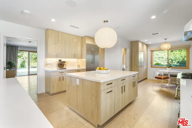 a kitchen with a sink stove and wooden cabinets
