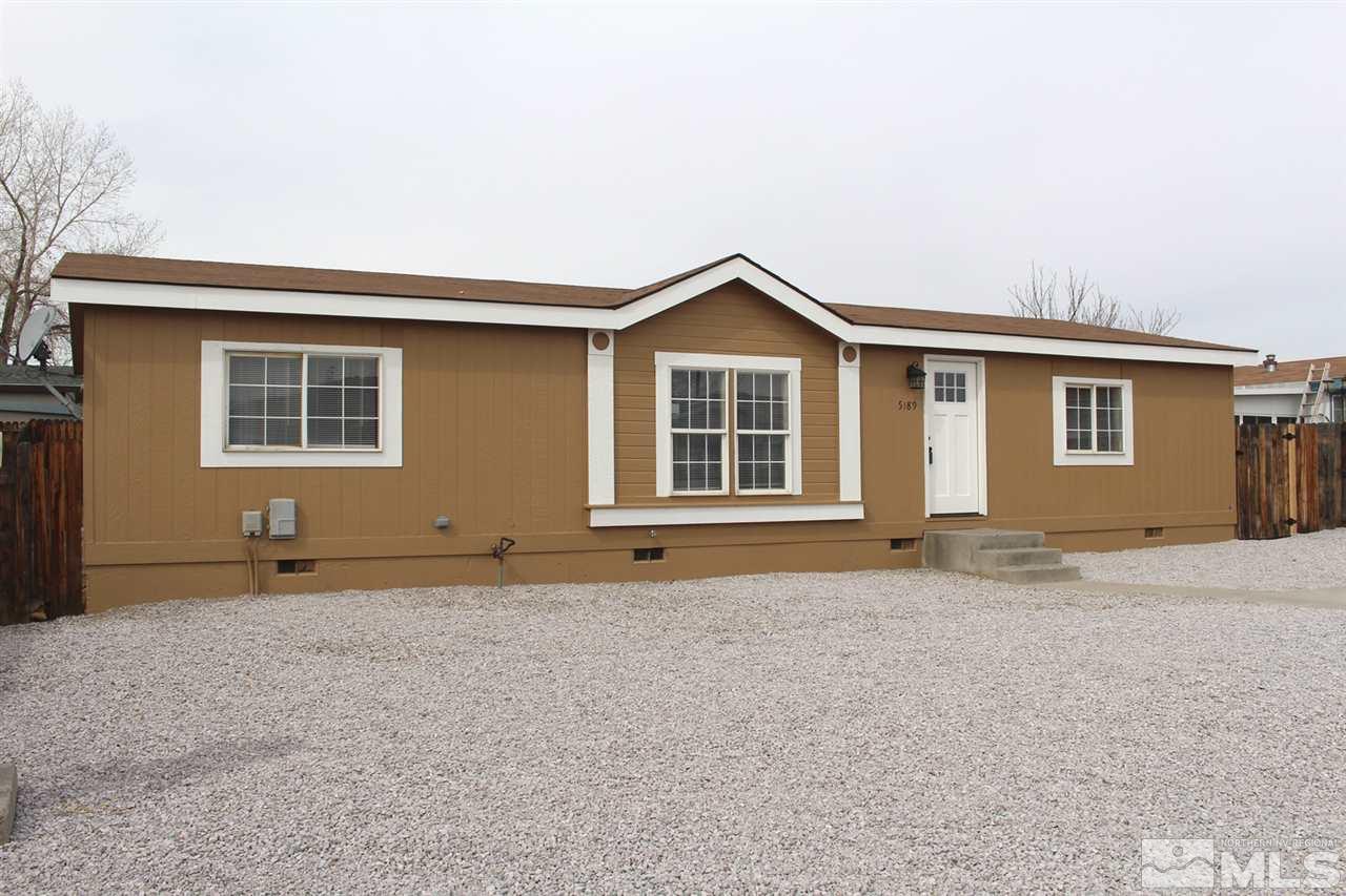 a view of a house with a yard and a garage