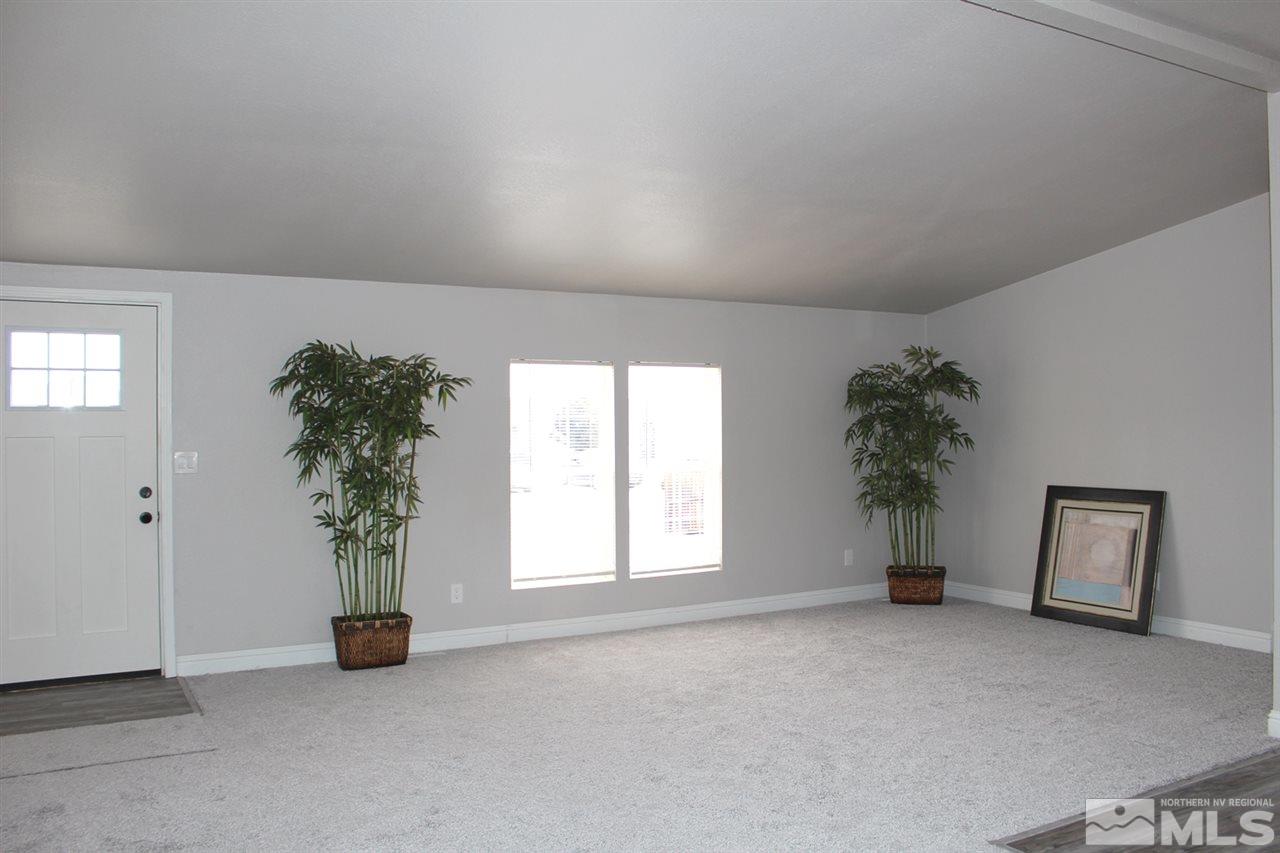 5189 Coggins Road Reno, NV 89506 - Photo 2 of 33 an empty room with windows and flower pot