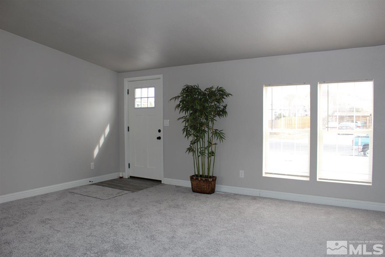 5189 Coggins Road Reno, NV 89506 - Photo 3 of 33 an empty room with windows and flower plants