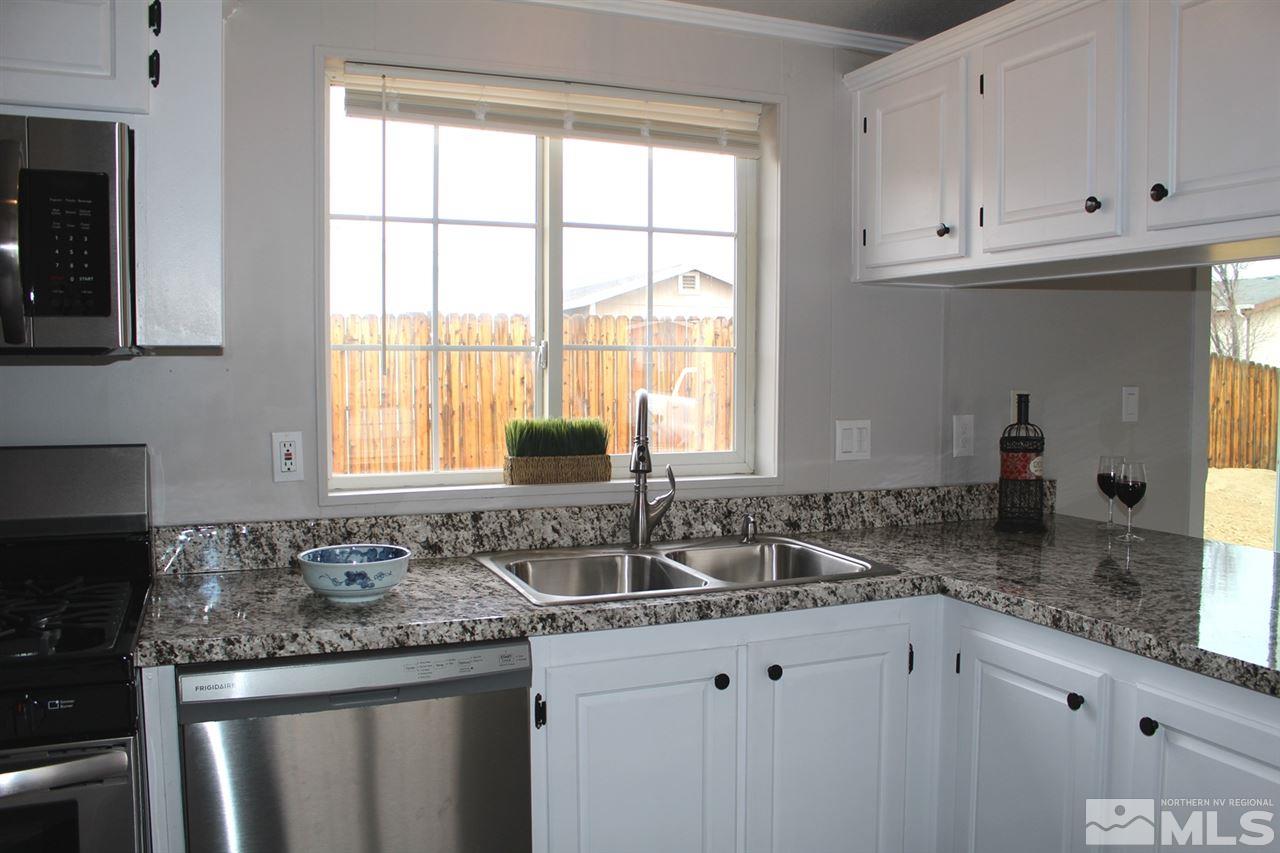 5189 Coggins Road Reno, NV 89506 - Photo 6 of 33 a kitchen with granite countertop a sink and a window