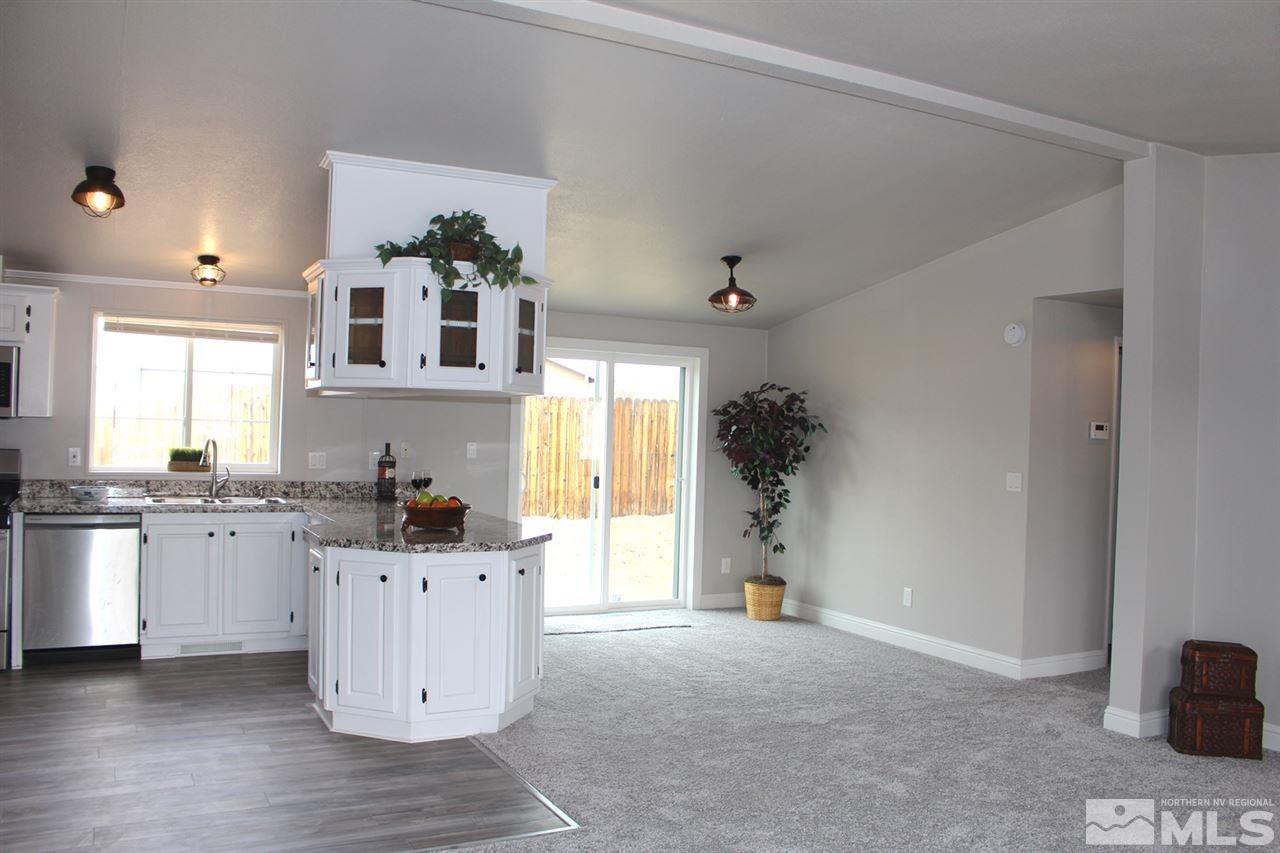 5189 Coggins Road Reno, NV 89506 - Photo 7 of 33 a kitchen with granite countertop a sink and cabinets