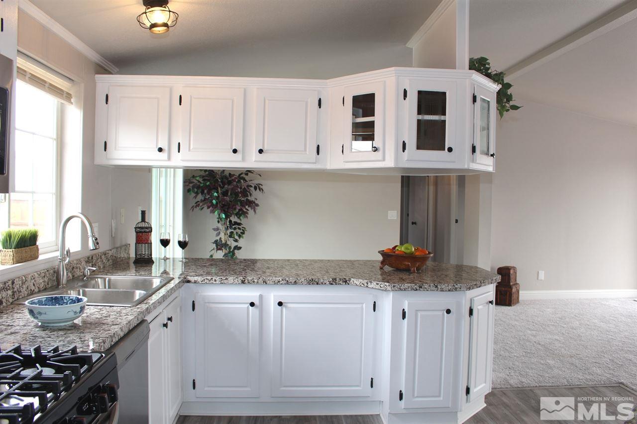 5189 Coggins Road Reno, NV 89506 - Photo 8 of 33 a kitchen with granite countertop a sink and cabinets