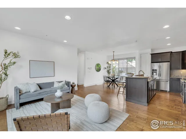 a living room with furniture and kitchen view
