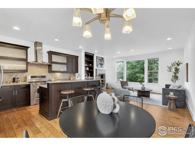 a open kitchen with kitchen island granite countertop a sink cabinets and stainless steel appliances